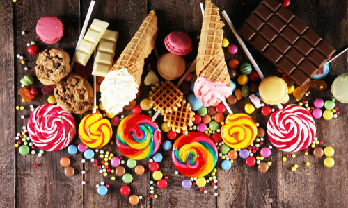 assortment of candies and desserts on table