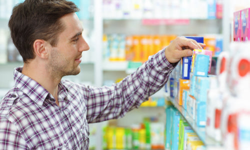 man choosing products in drugstore