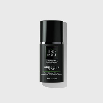 Skin care product bottle labeled 'Tiege Hanley Look Good Drops' on a light gray background